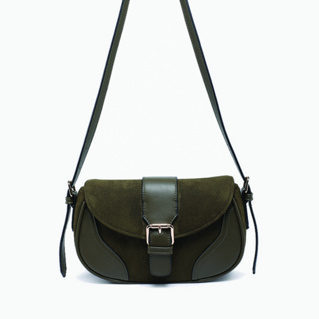 Green suede handbag with a strap on a white background