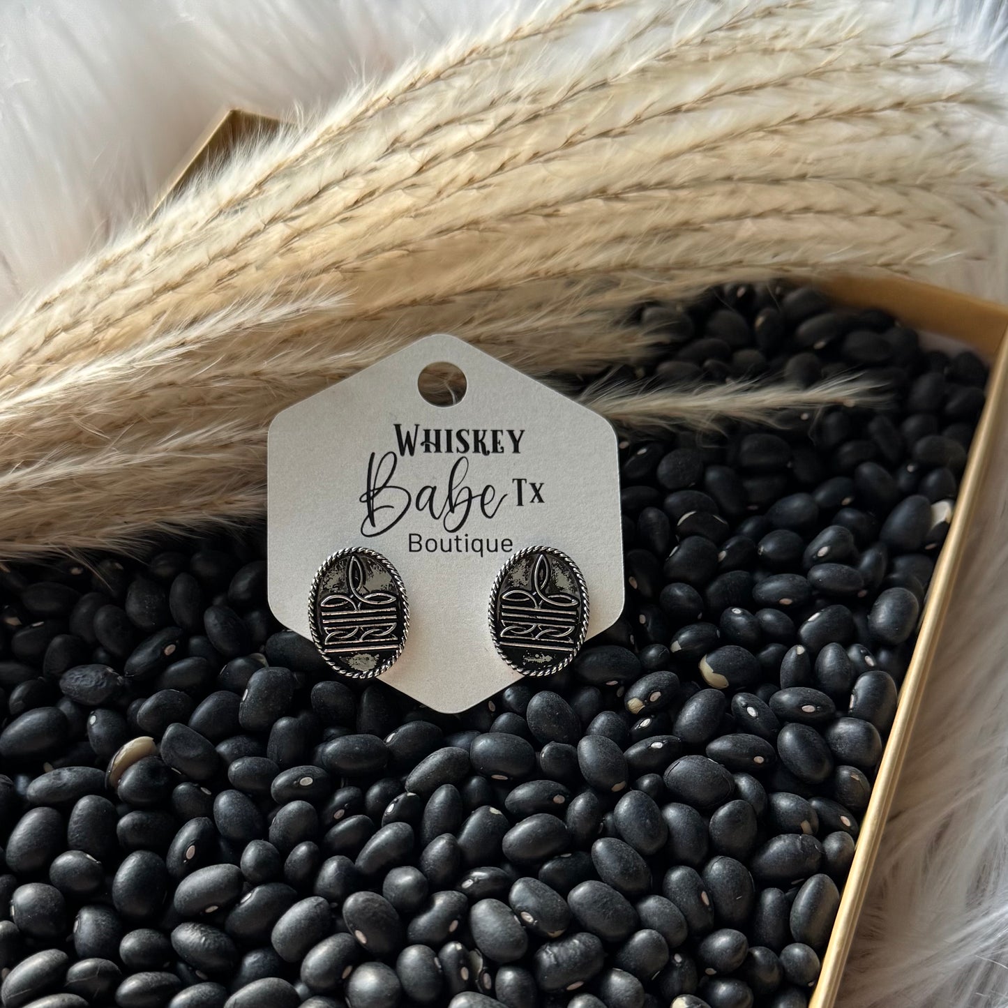 Silver oval stud earrings with bootstitch pattern