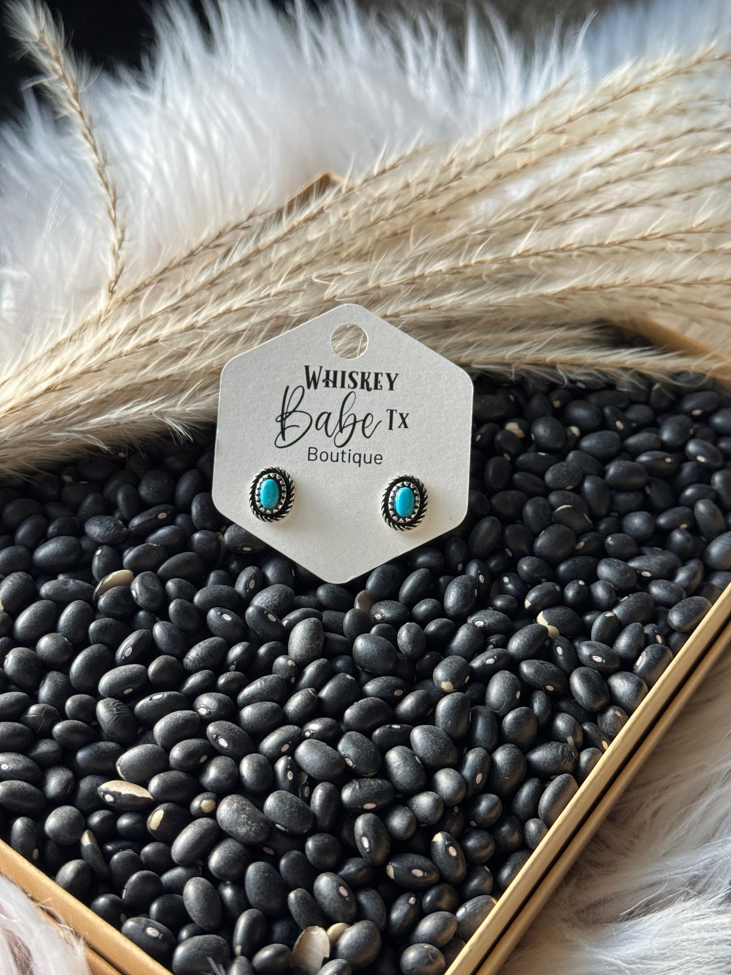 Turquoise earrings on a 'Whiskey Babe TX Boutique' card with black beans and decorative elements.