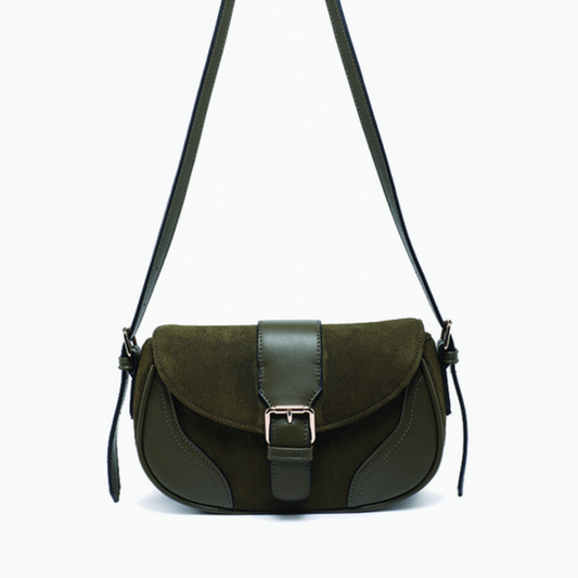 Green suede handbag with a strap on a white background