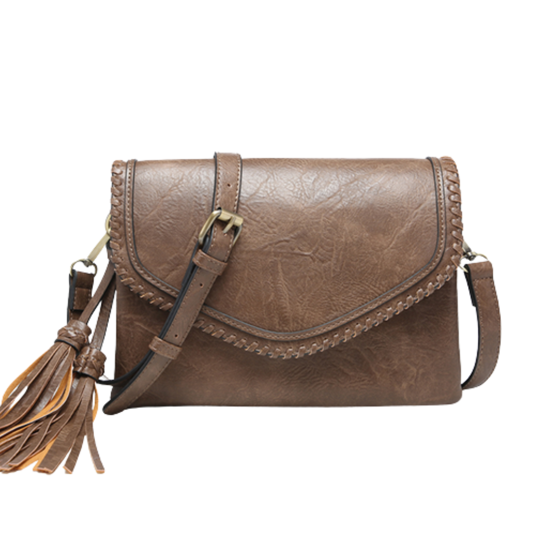 Brown leather handbag with tassel on a white background