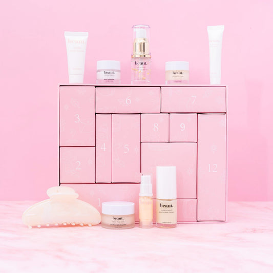 Pink advent calendar with skincare products on a pink background