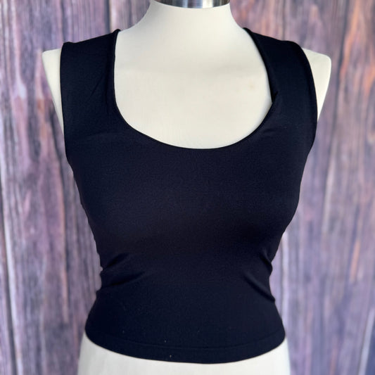 Black tank top on a mannequin against a wooden background