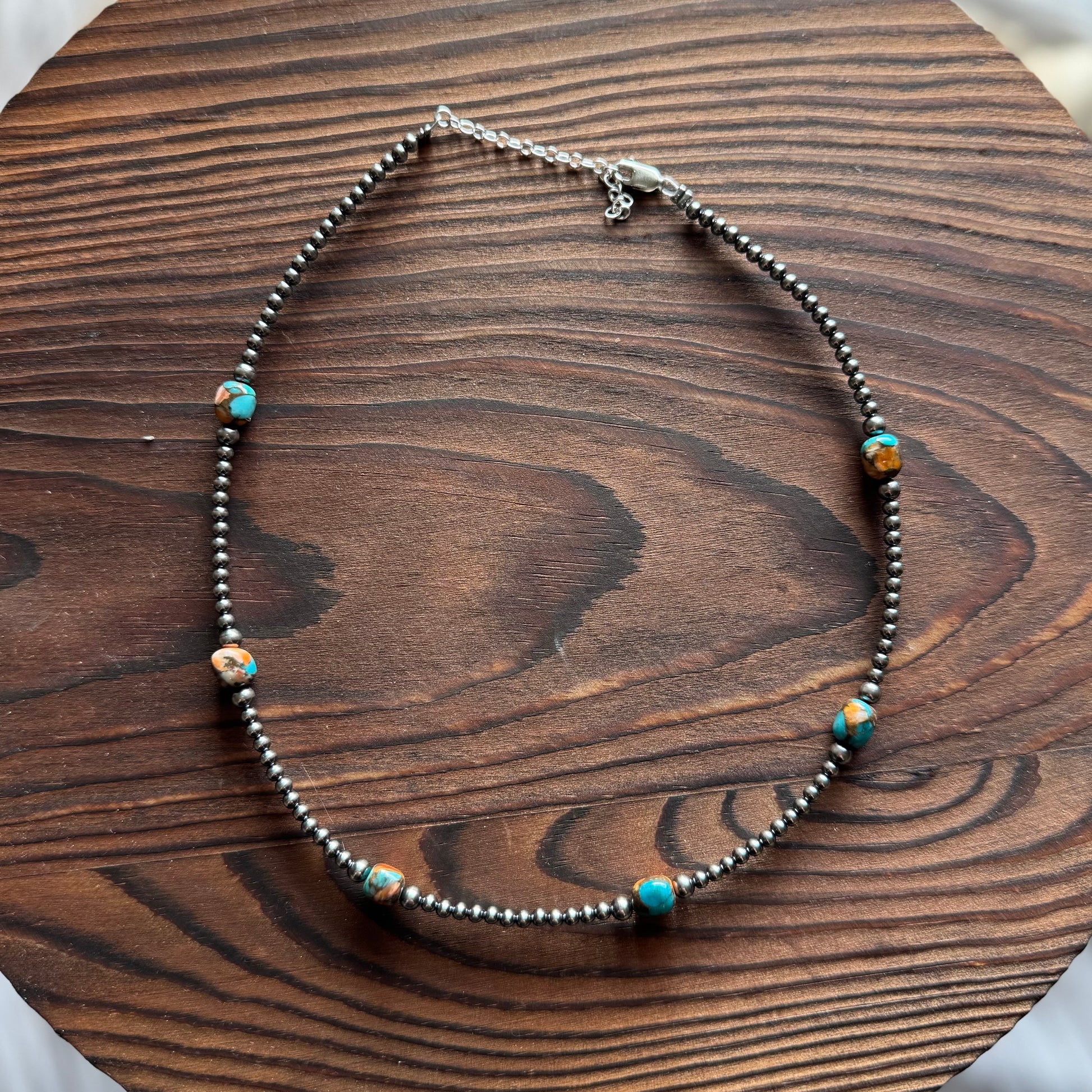 Necklace with beads on a wooden surface