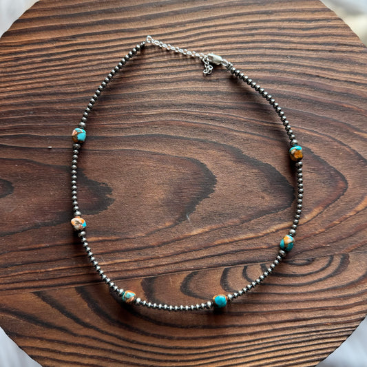 Necklace with beads on a wooden surface
