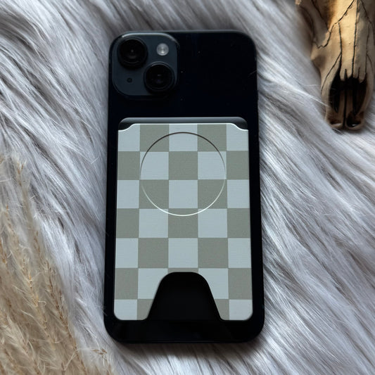 Phone case wallet with checkered design on a fluffy surface