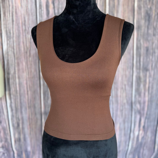 Brown tank top on a mannequin against a wooden background